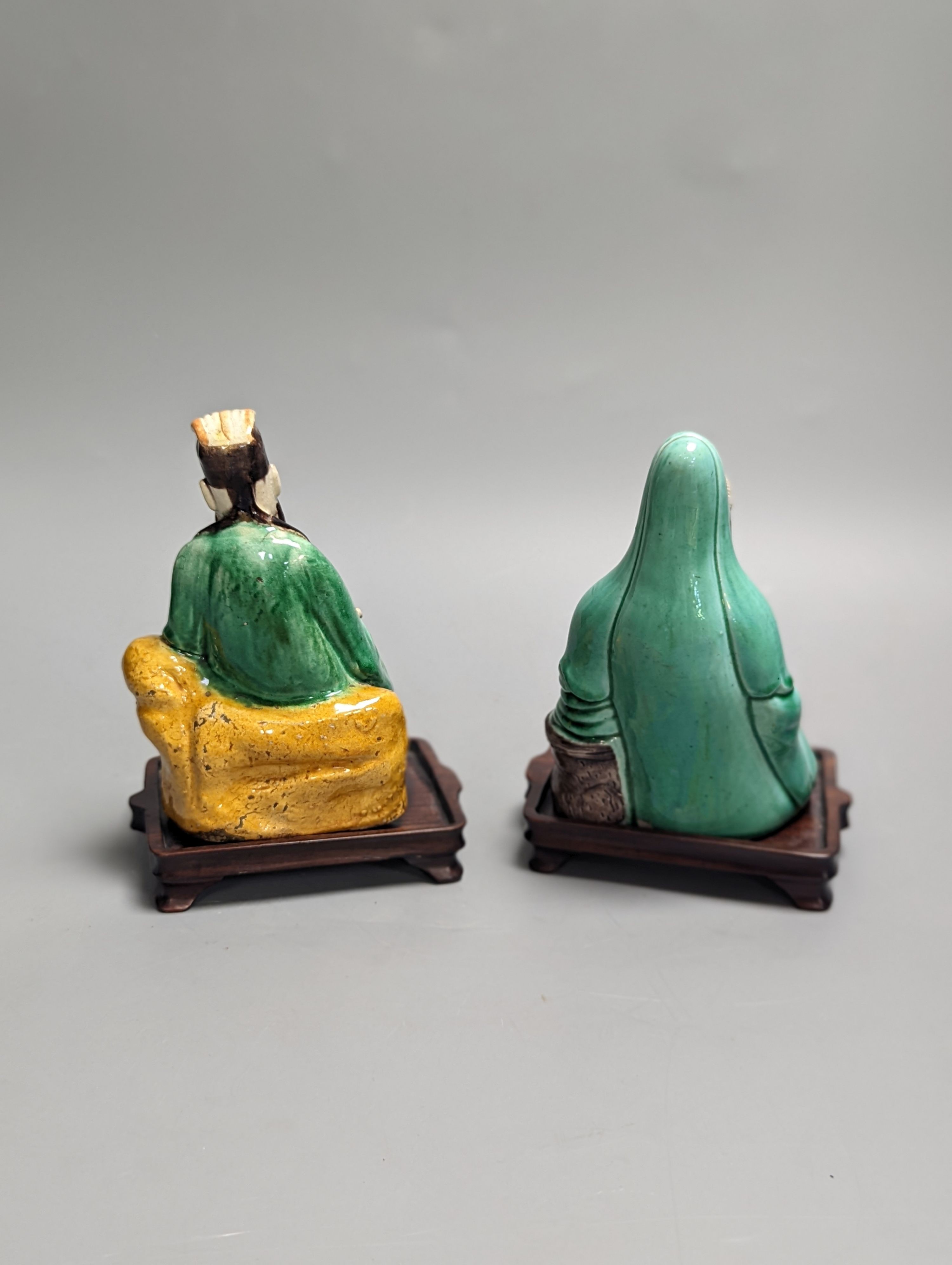 An 18th century Chinese sancai biscuit group of Guanyin with child and a 19th century Chinese sancai figure of Lu Dongbin, associated hardwood stands. 16cm